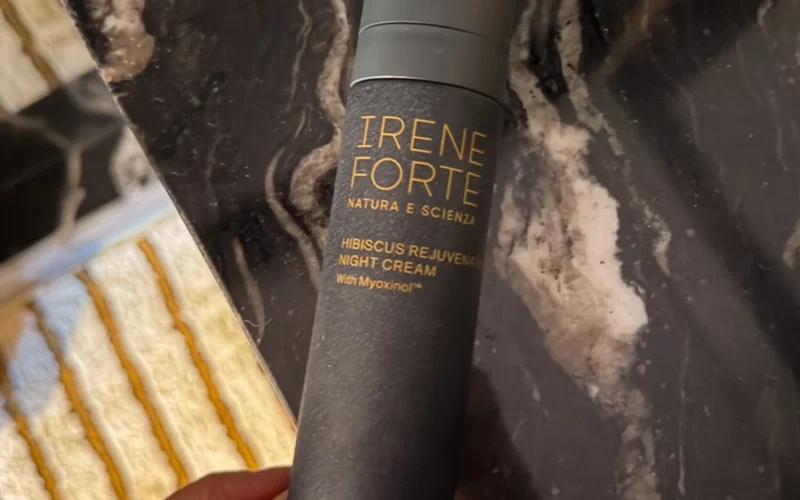 Hand holding Irene Forte Hibiscus night cream bottle