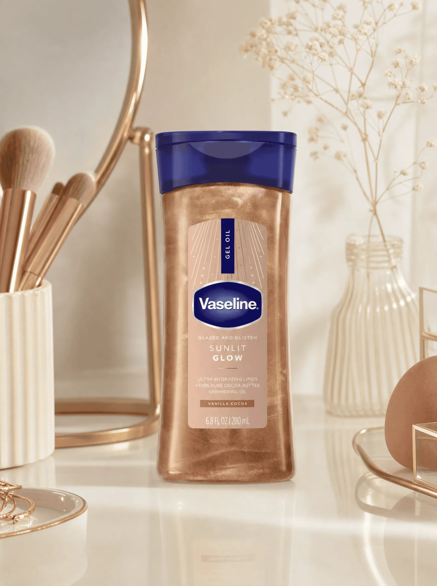 Vaseline Glazed and Glisten shimmer body oil bottle on a vanity