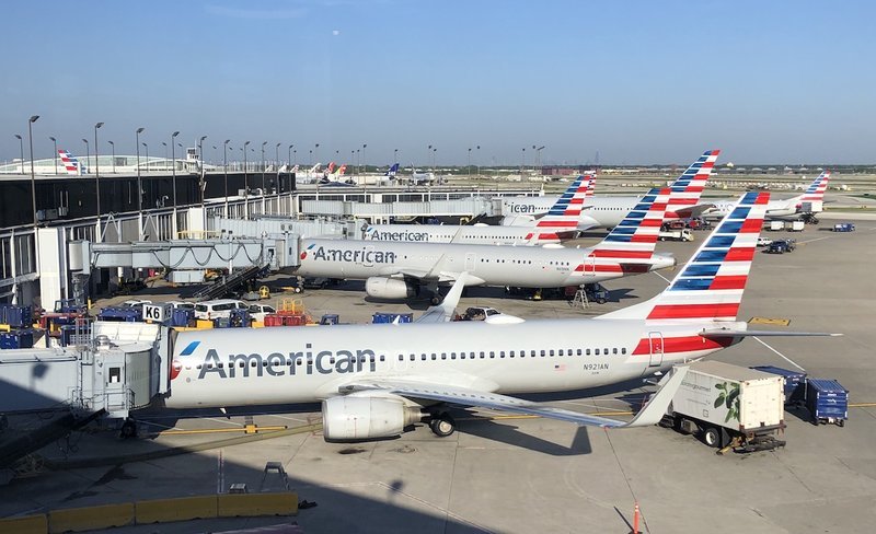 Multiple American Airlines aircraft parked at airport gates
