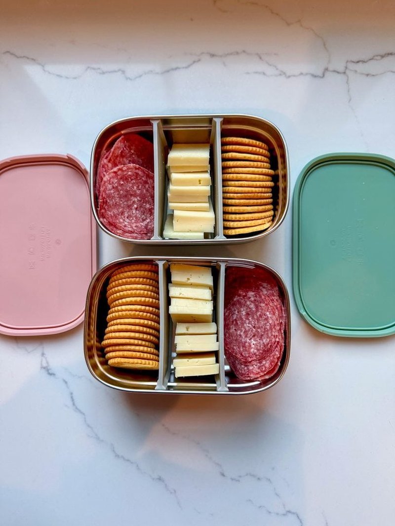 Stainless bento lunch boxes with cheese, meat, and crackers