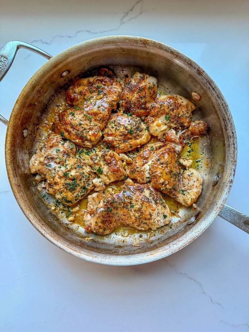 Lemon dijon chicken glazed in a stainless steel skillet